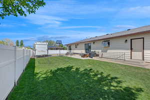 View of yard featuring a patio, a fenced backyard, and entry steps