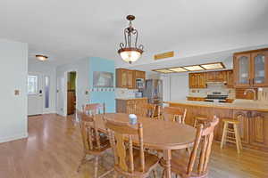 Dining room with baseboards and light wood-type flooring