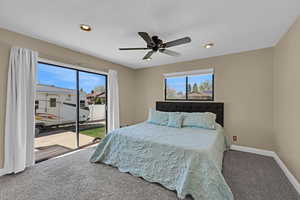 Carpeted bedroom featuring access to outside, recessed lighting, baseboards, and multiple windows