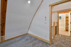 Carpeted spare room featuring baseboards