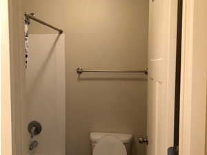 Full bathroom featuring shower / bath combination and toilet