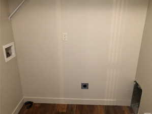 Clothes washing area with washer hookup, hookup for an electric dryer, laundry area, baseboards, and dark wood-style floors