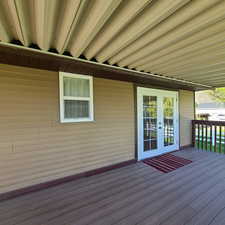 Large covered deck featuring French doors from Master Bedroom