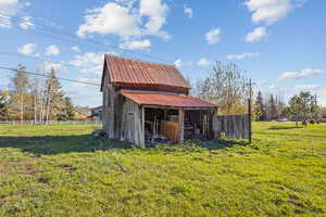 View of outdoor structure with fence and an outdoor structure