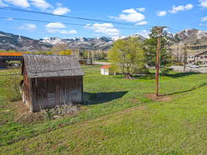 View of yard featuring an outdoor structure, a mountain view, and a shed