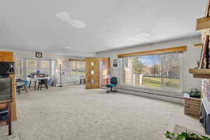 Unfurnished living room with a fireplace and carpet flooring