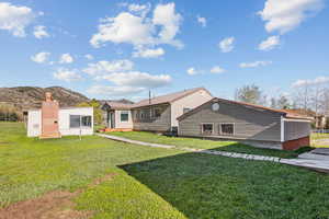 Rear view of property featuring a yard