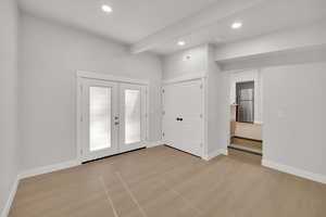 Entrance foyer with baseboards, french doors, and recessed lighting