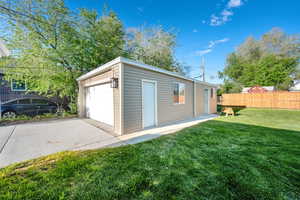 Detached garage featuring fence