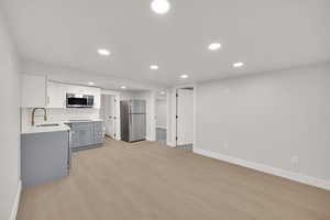 Kitchen featuring baseboards, a sink, appliances with stainless steel finishes, and recessed lighting