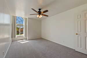 Unfurnished room featuring baseboards, a ceiling fan, and carpet