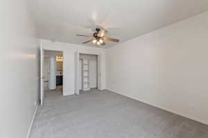 Unfurnished bedroom with baseboards, a ceiling fan, a closet, and light carpet