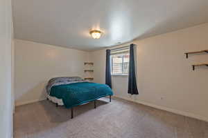 Carpeted bedroom featuring baseboards