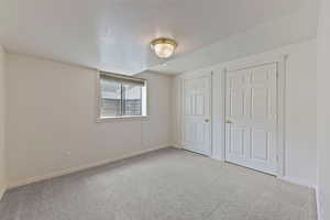 Unfurnished bedroom with baseboards and carpet flooring