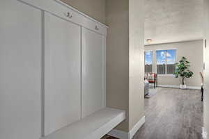 Mudroom with baseboards and wood finished floors