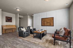 Living area featuring baseboards, wood finished floors, and visible vents