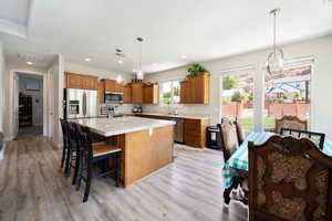 Kitchen featuring visible vents, light wood-type flooring, appliances with stainless steel finishes, and a center island