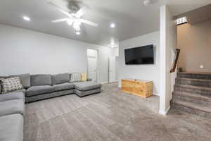Living room featuring carpet flooring, ceiling fan, recessed lighting, baseboards, and stairway