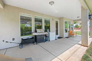View of patio with a grill