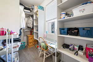 Walk in closet featuring carpet