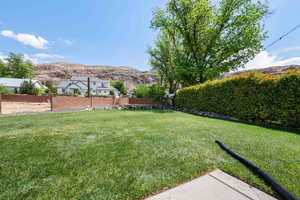 View of yard with fence and a mountain view