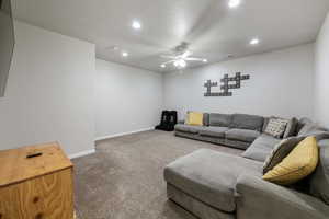 Carpeted living room with recessed lighting, baseboards, ceiling fan, and visible vents