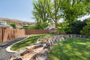 View of yard featuring fence and a mountain view