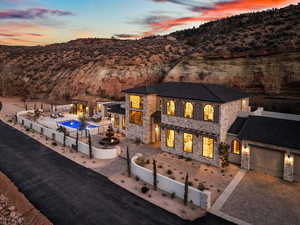 Exterior space with fence private yard, an attached garage, a mountain view, and stone siding