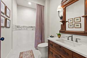 Bathroom featuring vanity, recessed lighting, a shower with shower curtain, and toilet