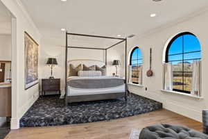 Bedroom featuring crown molding, visible vents, wood finished floors, baseboards, and recessed lighting