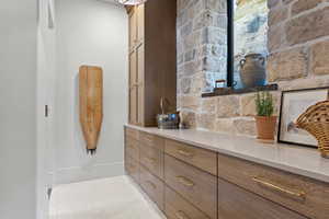 Bathroom with tile patterned floors and baseboards