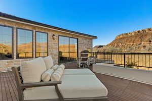 Deck with an outdoor living space and a mountain view