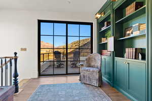 Sitting room featuring a mountain view, wood finished floors, and built in features