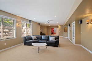 Living room with baseboards, light carpet, and recessed lighting