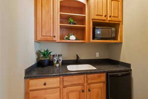 Bar featuring a sink and black appliances