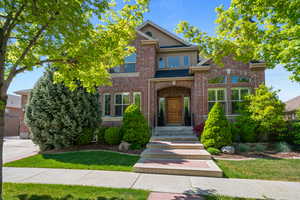 Traditional-style home featuring brick siding