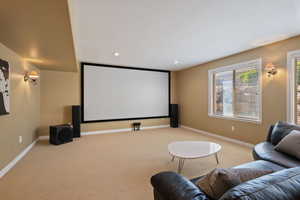 Cinema with light colored carpet, recessed lighting, baseboards, and a textured ceiling
