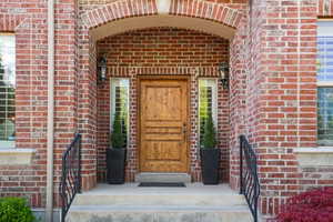 Entrance to property with brick siding