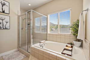 Full bathroom featuring a garden tub, baseboards, recessed lighting, tile patterned floors, and a shower stall