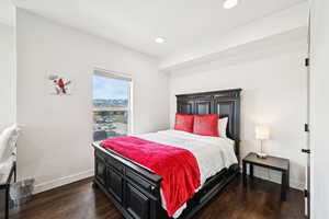 Bedroom with recessed lighting, baseboards, and dark wood-style floors