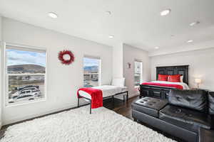 Bedroom with recessed lighting, baseboards, a mountain view, and dark wood-style floors