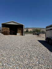 View of property exterior featuring fence and a mountain view