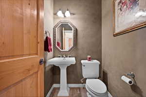 Bathroom with tile patterned flooring, baseboards, and toilet