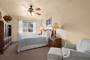 Carpeted bedroom #2 featuring baseboards, ceiling fan