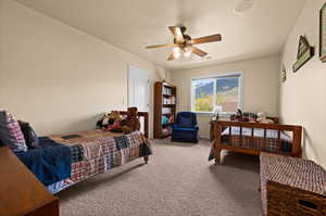 Carpeted bedroom #4 with ceiling fan