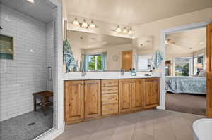 Primary bathroom featuring double vanity, a stall shower, tile patterned floors, connected bathroom, and recessed lighting