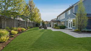 View of yard with french doors, a patio, an outdoor hangout area, and a fenced backyard