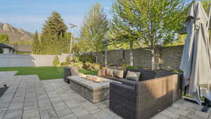 View of patio featuring a fenced backyard and an outdoor living space with a fire pit