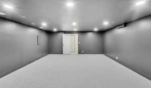 Finished basement with recessed lighting and baseboards