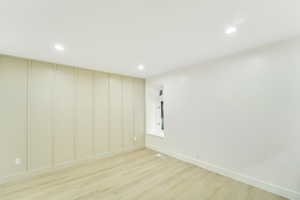 Empty room featuring recessed lighting, light wood-style floors, baseboards, and visible vents